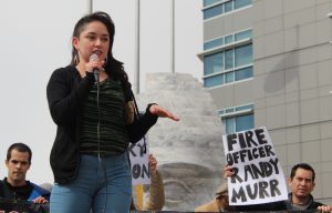 Ana Ortega speaks to a group of supporters about her experience being assaulted by Officer Nixon in 2009. (photo: The Nation Report)