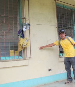 Vitalino Alvarez shows a US human rights delegation the bullet holes left after shots were fired at a structure where single mothers were housed. No one was killed or injured in that particular shooting but members reported that the shootings into their community as a regular occurrence. (photo: The Nation Report)