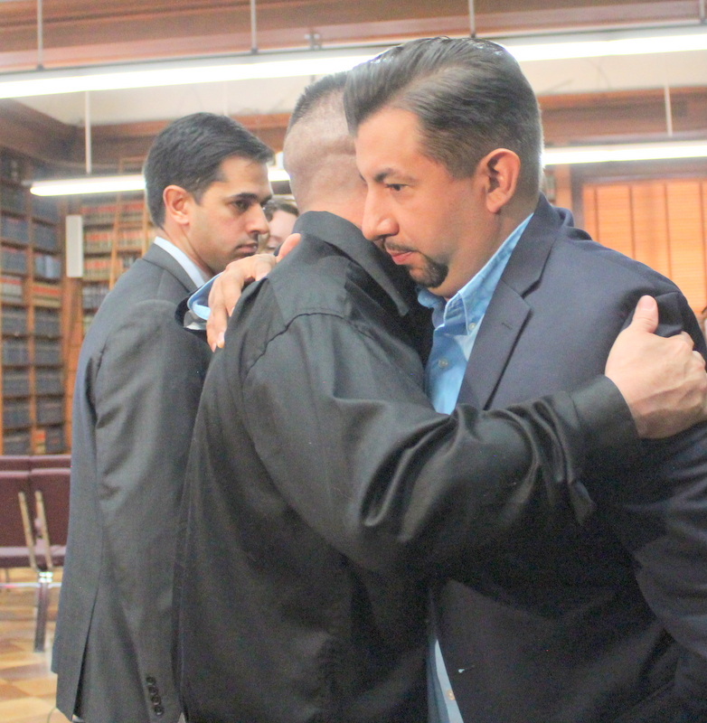 Denver City Council member hugs Jose Hernandez, father of Jessica Hernandez on April 12 after the announcement of the settlement by city officials.